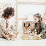 photo of girls playing with wooden toys